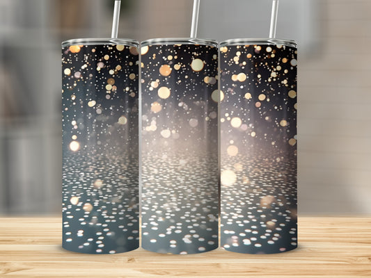 Three tumblers with a bokeh light effect design on a wooden surface.