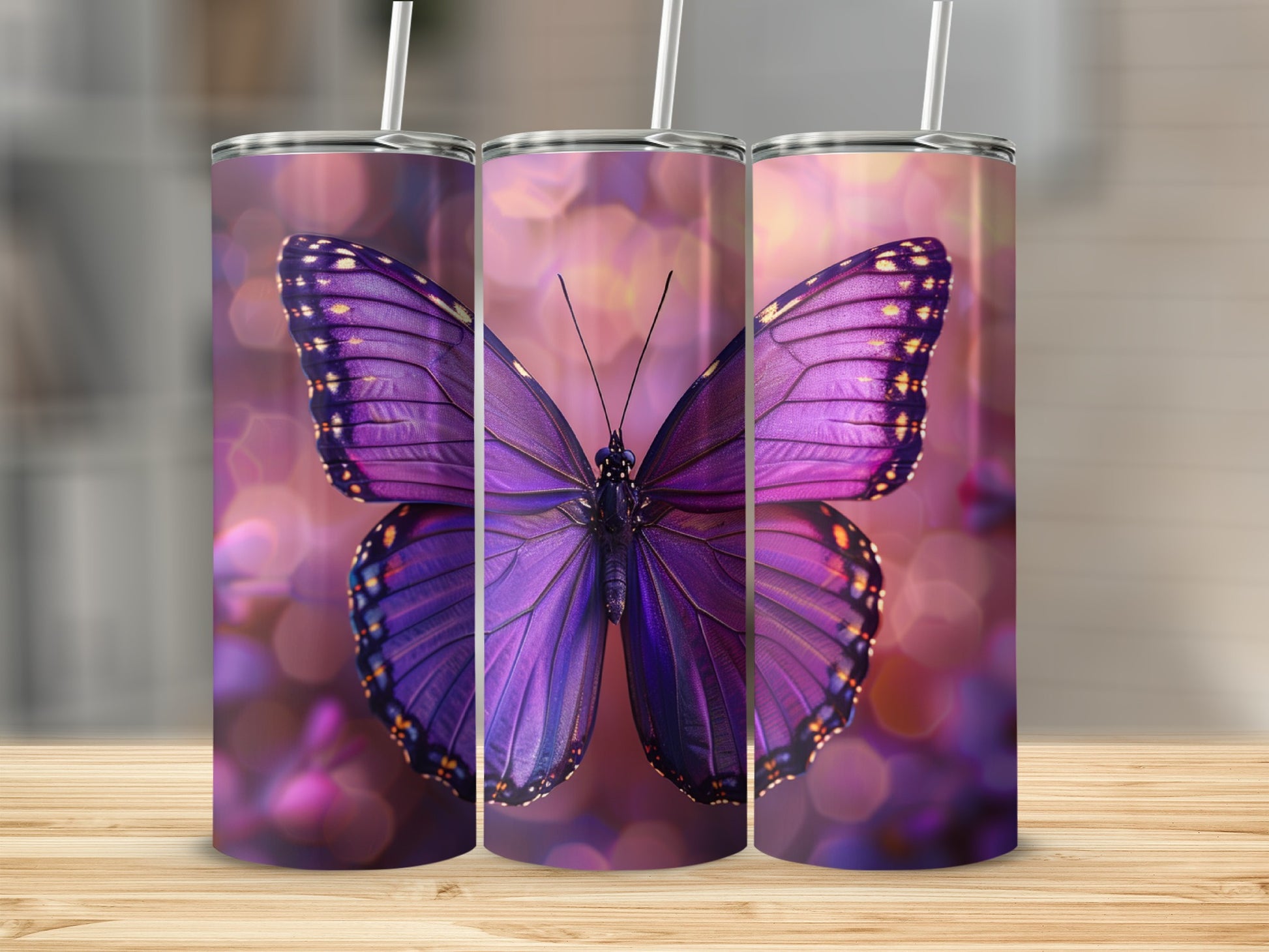 Three tumblers featuring a vibrant purple butterfly against a bokeh background.