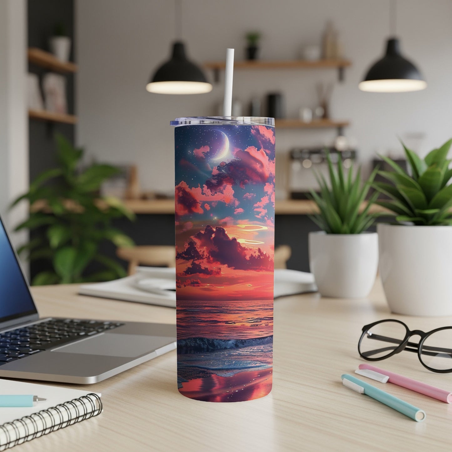 Tumbler with sunset ocean scene and celestial details.