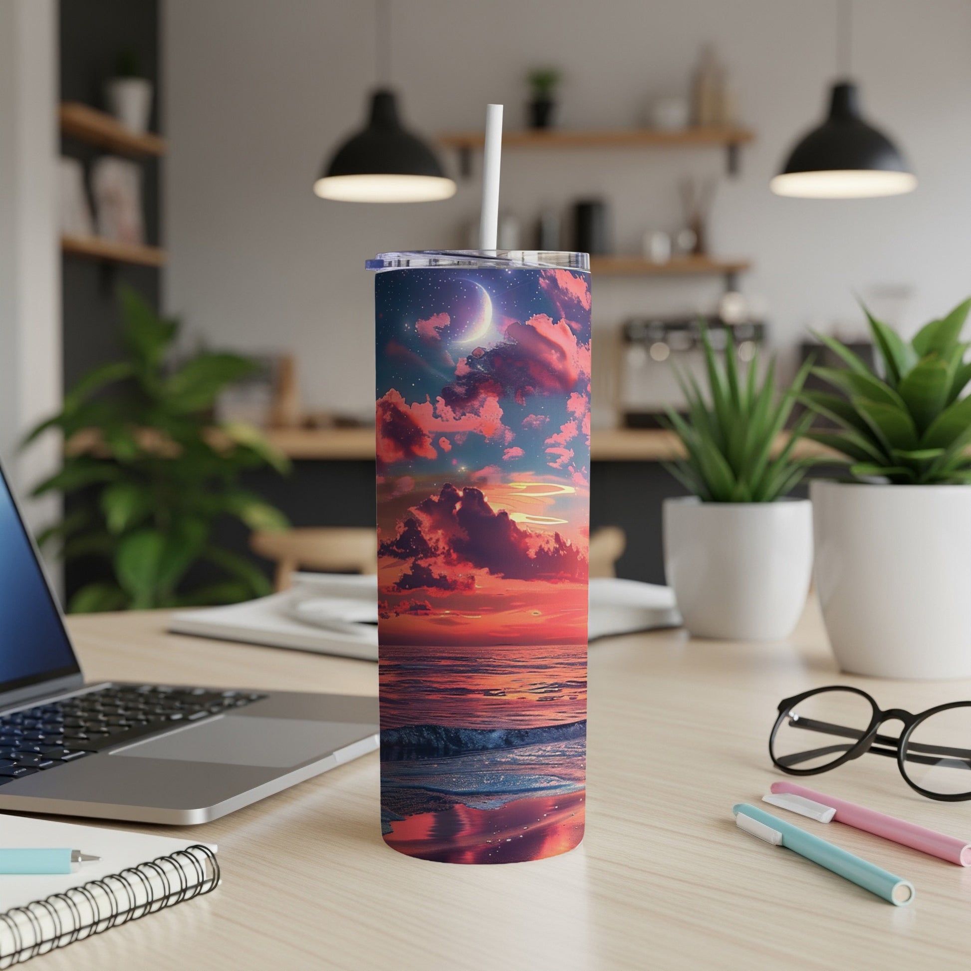 Tumbler with sunset ocean scene and celestial details.
