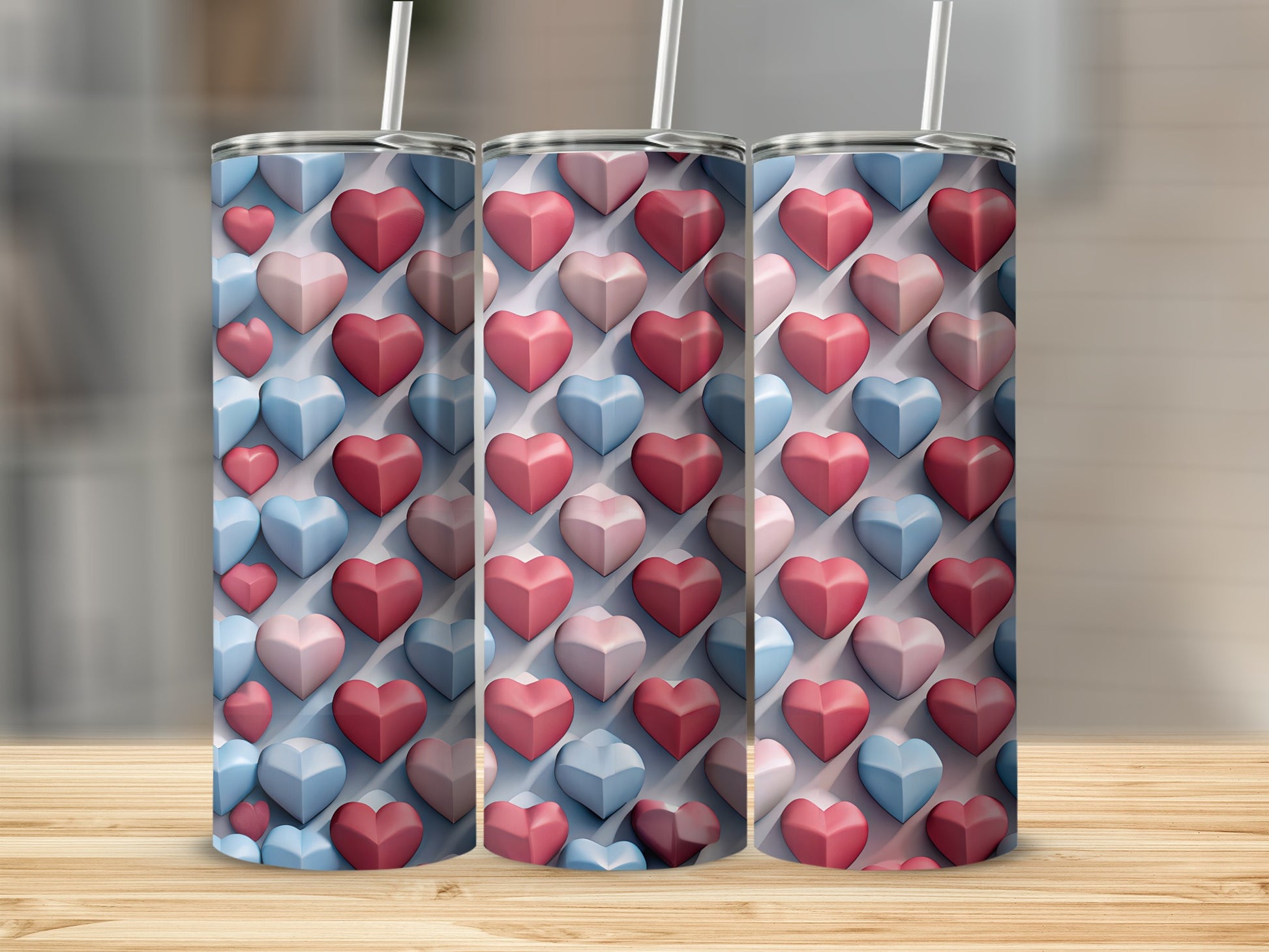 Three tumblers with a repeating pattern of pink and blue raised hearts.