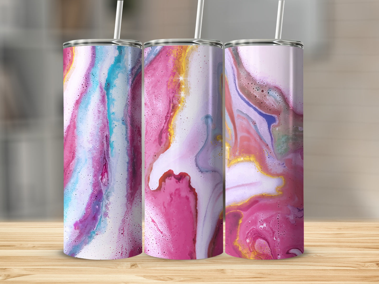 Three tumblers with a pink, blue, and gold abstract fluid marble design.
