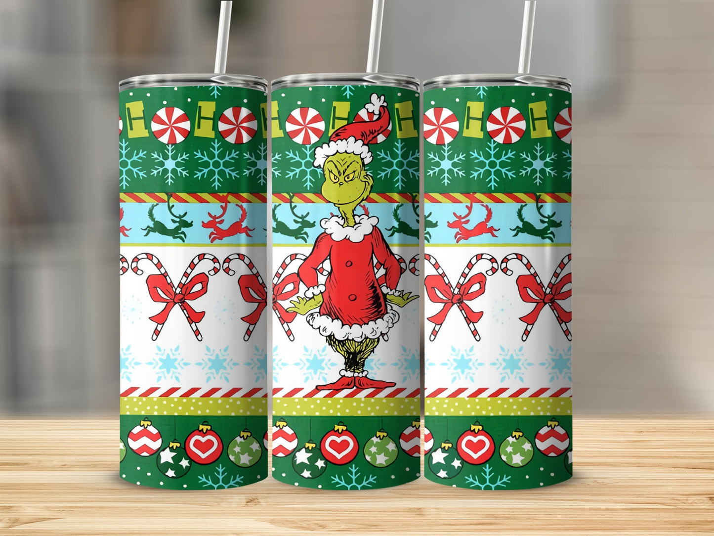 The Grinch wearing a Santa suit on a festive Christmas tumbler.