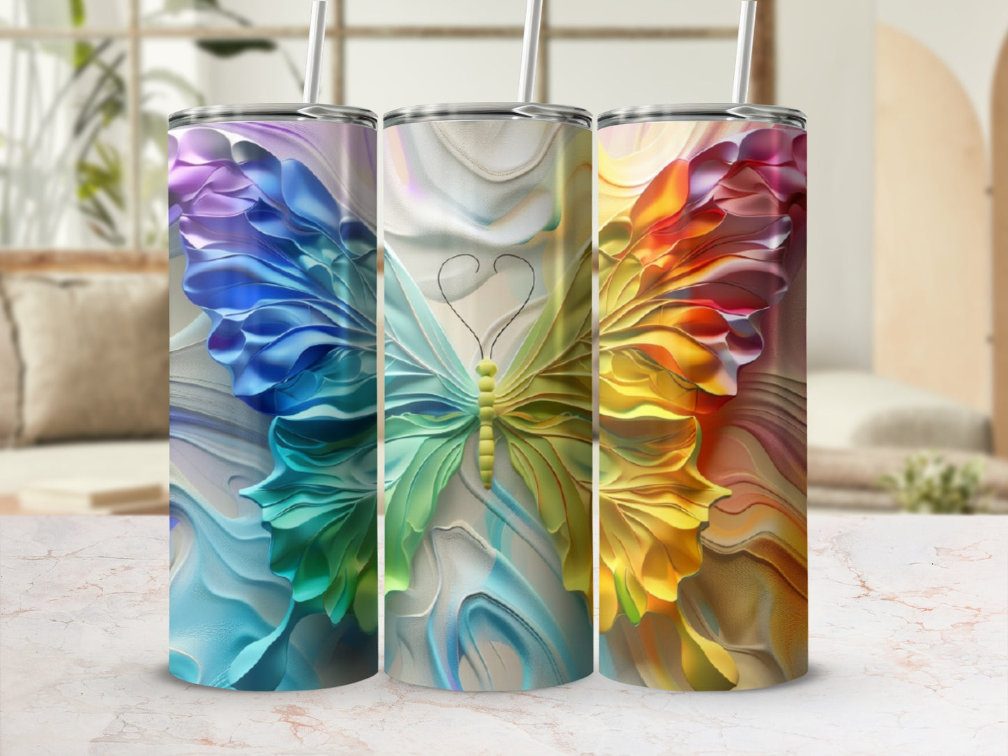 Three tumblers with vibrant butterfly designs in blue, green, and orange.