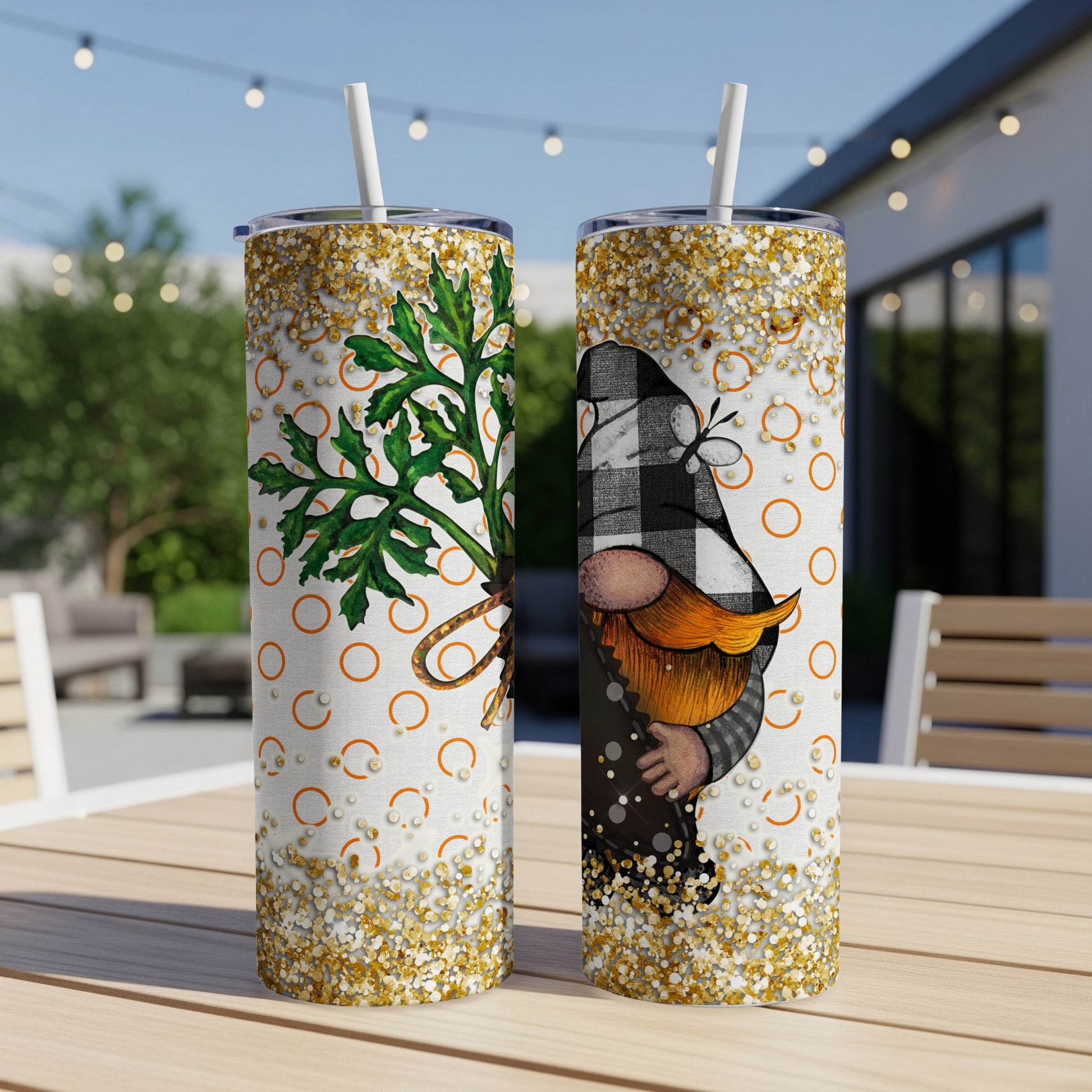Two tumblers featuring a gnome and a carrot design with gold glitter accents.