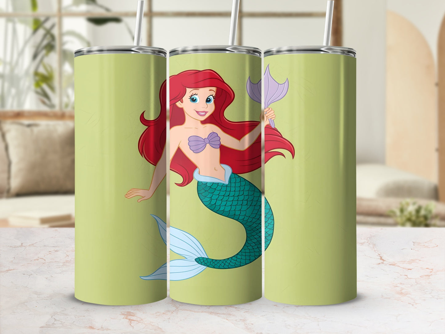Ariel from The Little Mermaid on a pastel green tumbler.