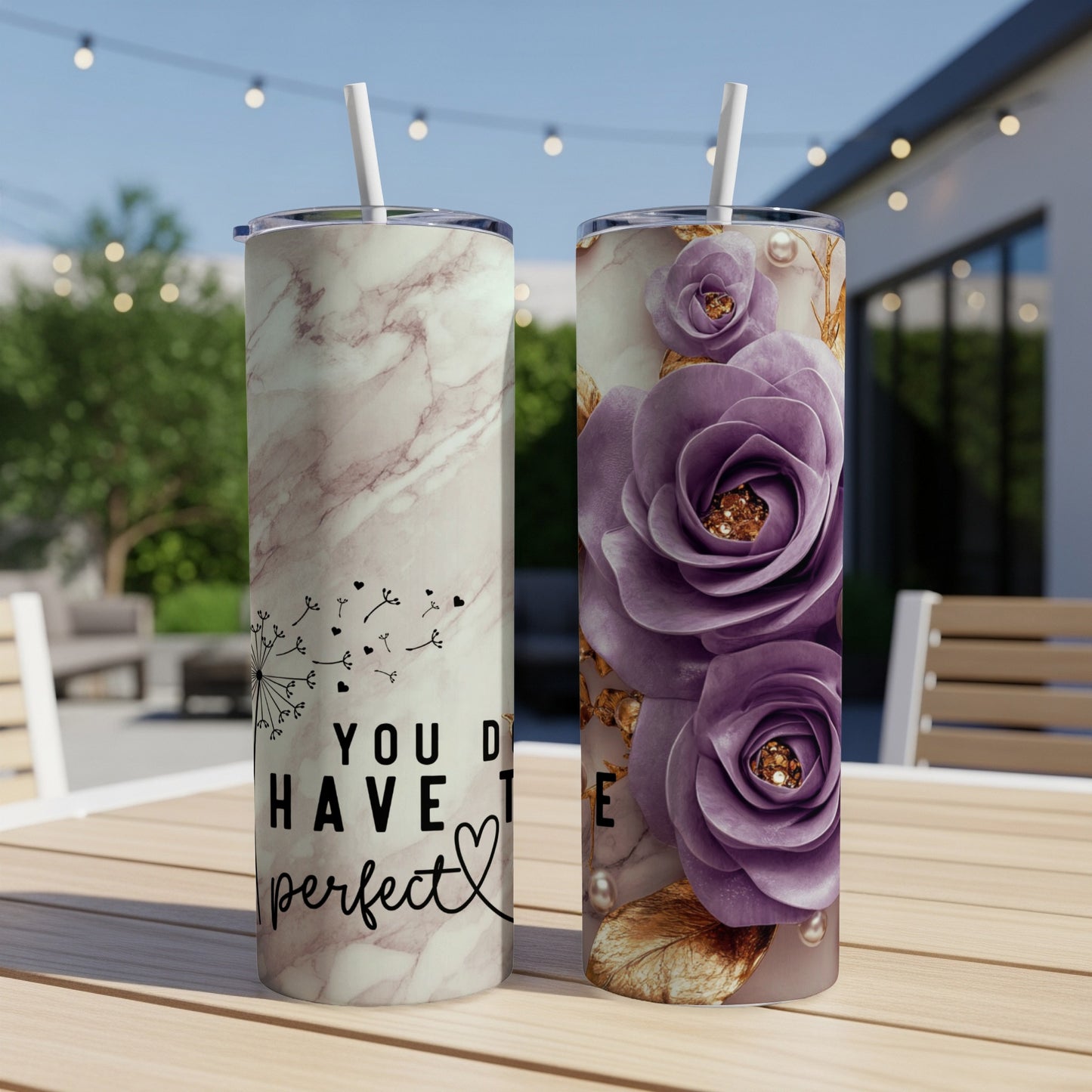 Two tall tumblers on a table, one with marble and dandelion, one with purple roses.