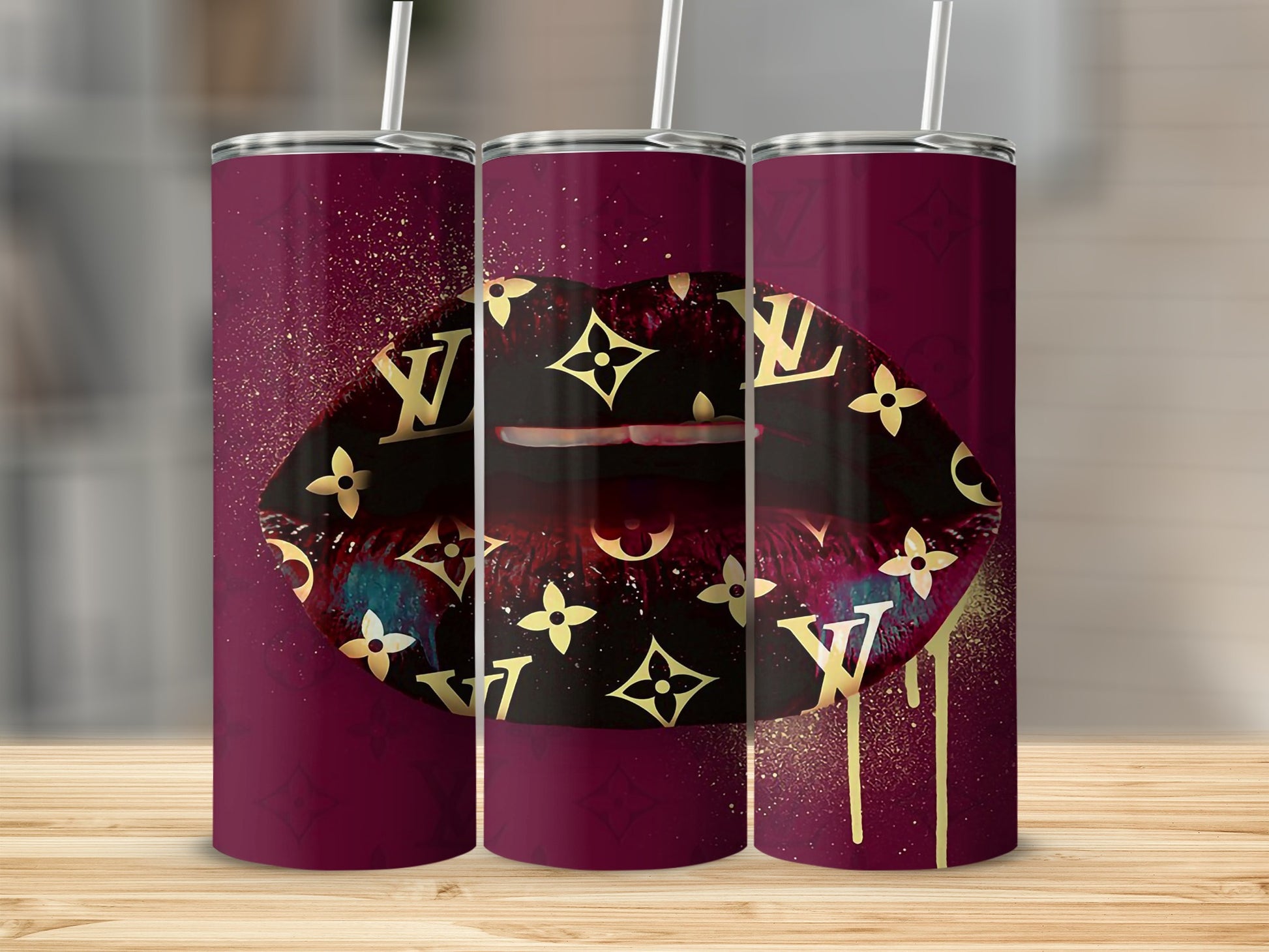 Three tumblers with a dark red background and gold LV logo pattern.
