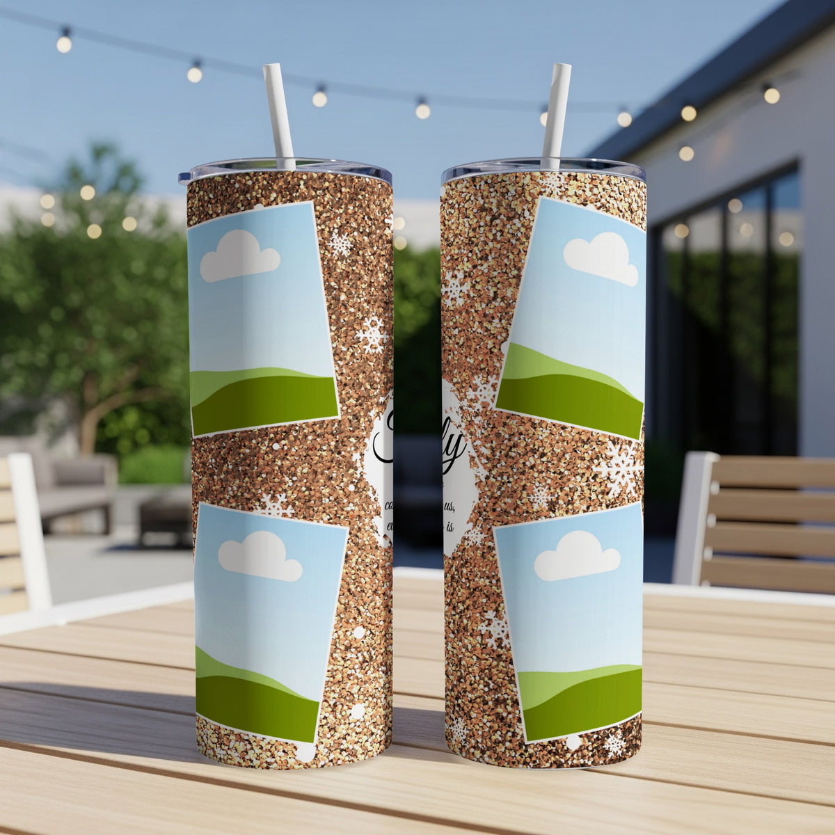 Two glitter tumblers with photo frames, clouds, and snowflakes sit on a wooden table.
