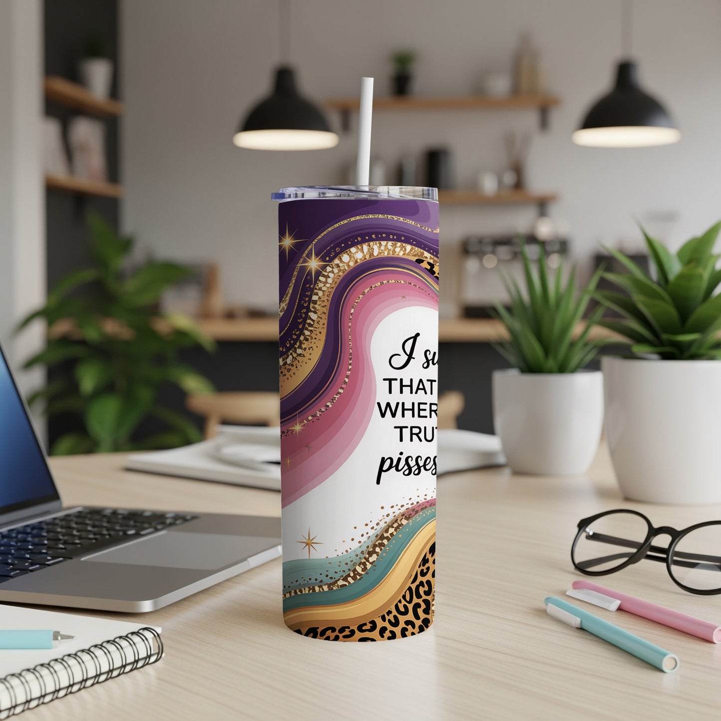 Tumbler with purple, pink, and gold abstract design and leopard print.
