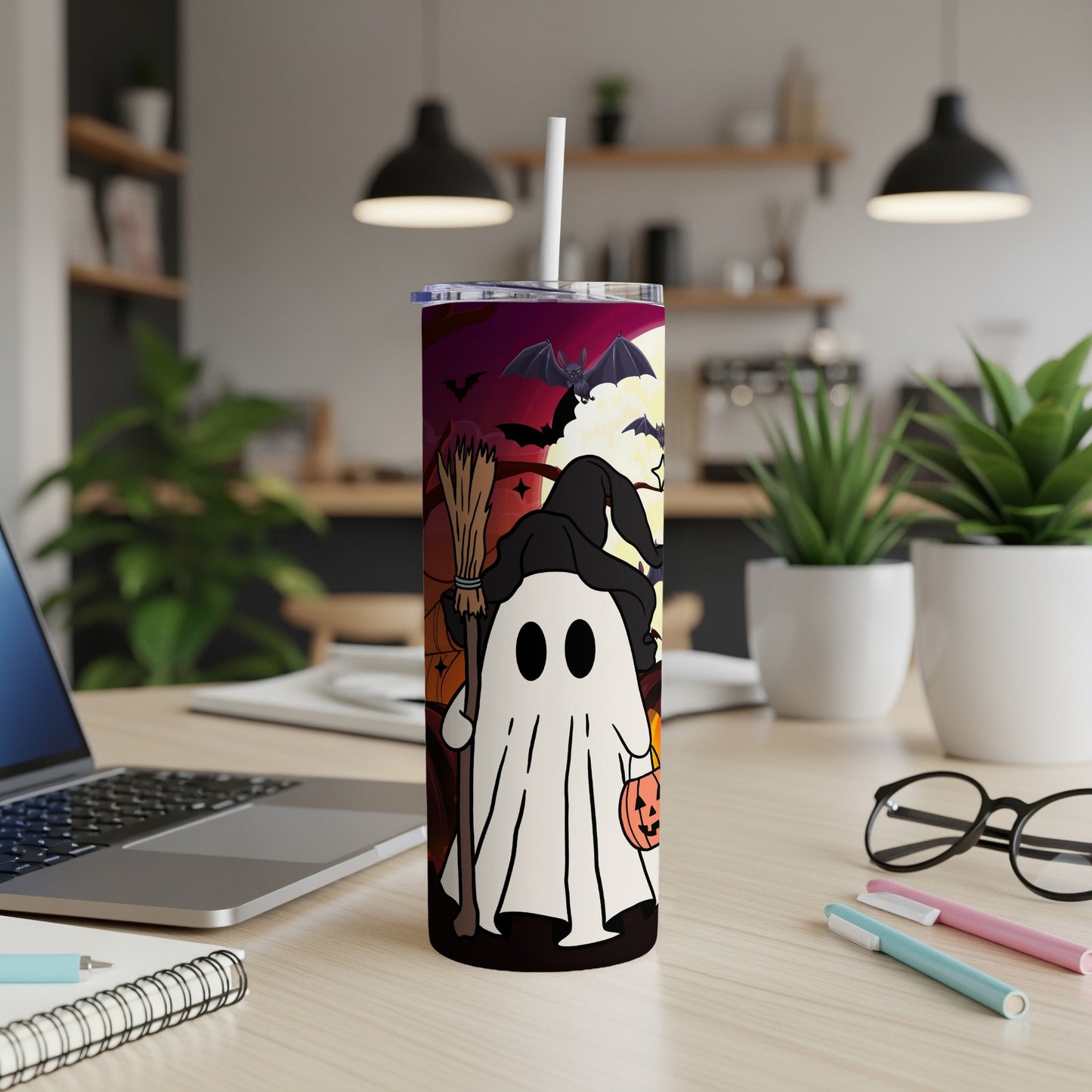Halloween tumbler with ghost holding broom and pumpkin, surrounded by bats and moon.