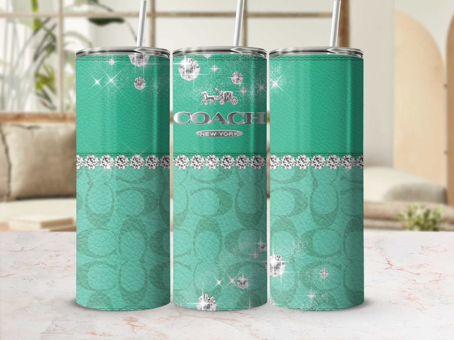 Coach New York tumbler with diamonds and horse and carriage logo.