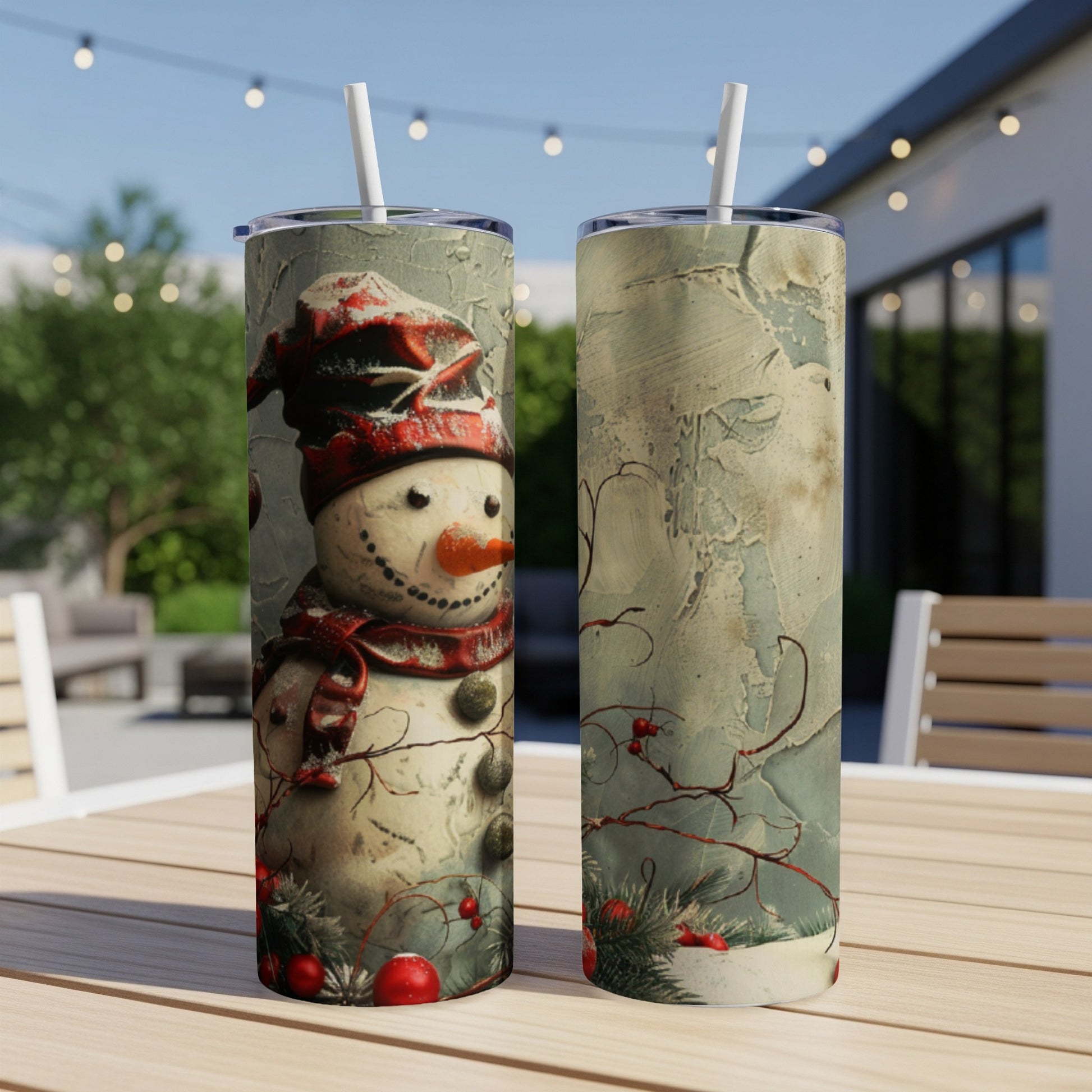 Two tumblers with a snowman design, one showing the full snowman.