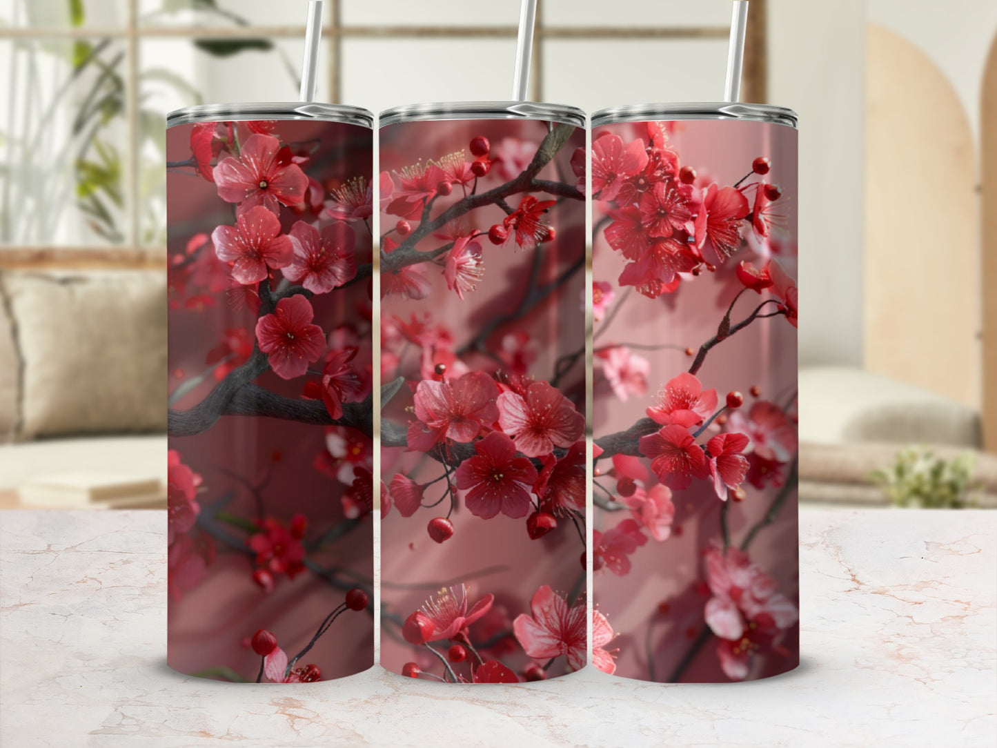 Three red cherry blossom tumblers on a marble countertop.