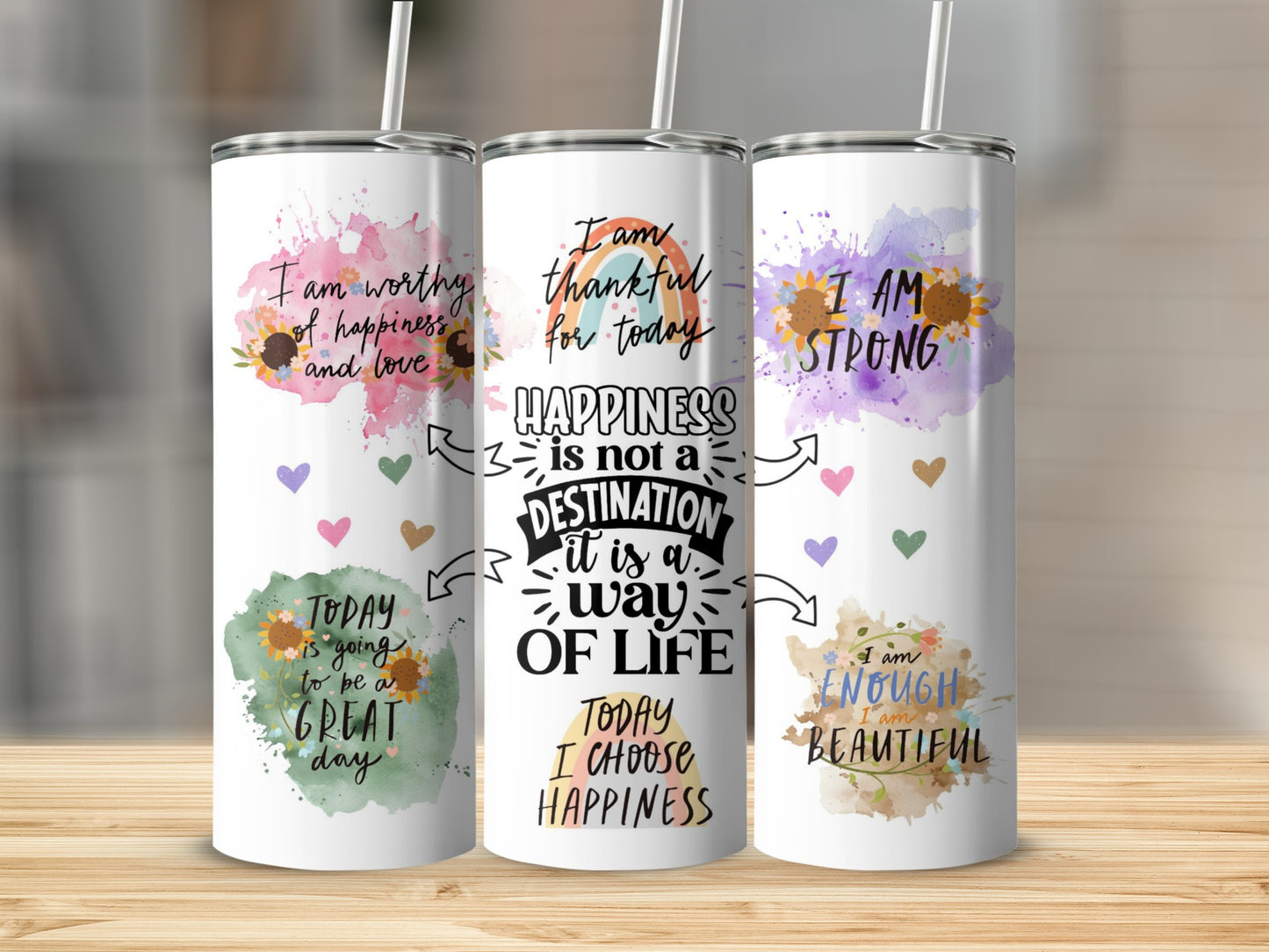 Three tumblers with inspirational quotes and watercolor floral designs.