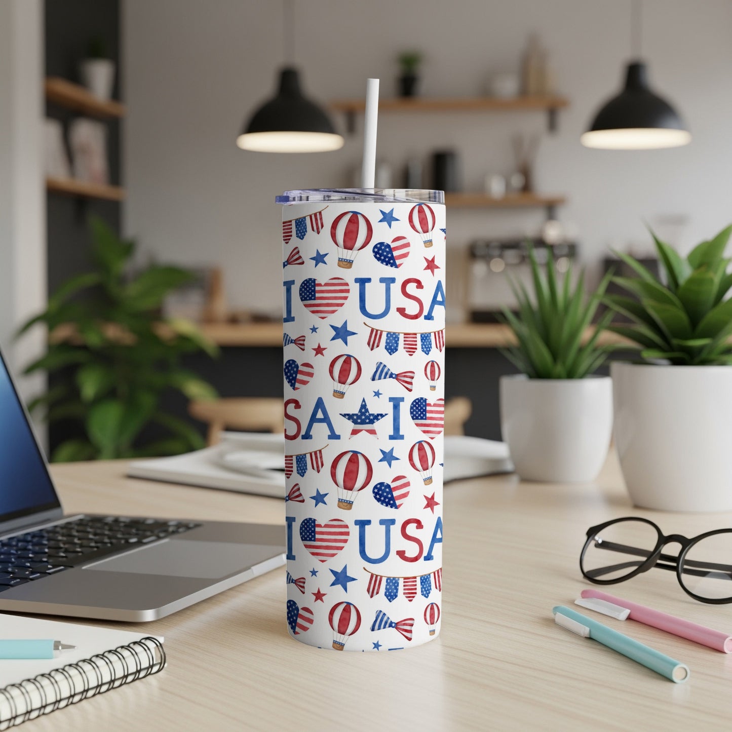 White tumbler with USA, heart, and star pattern, featuring a straw.