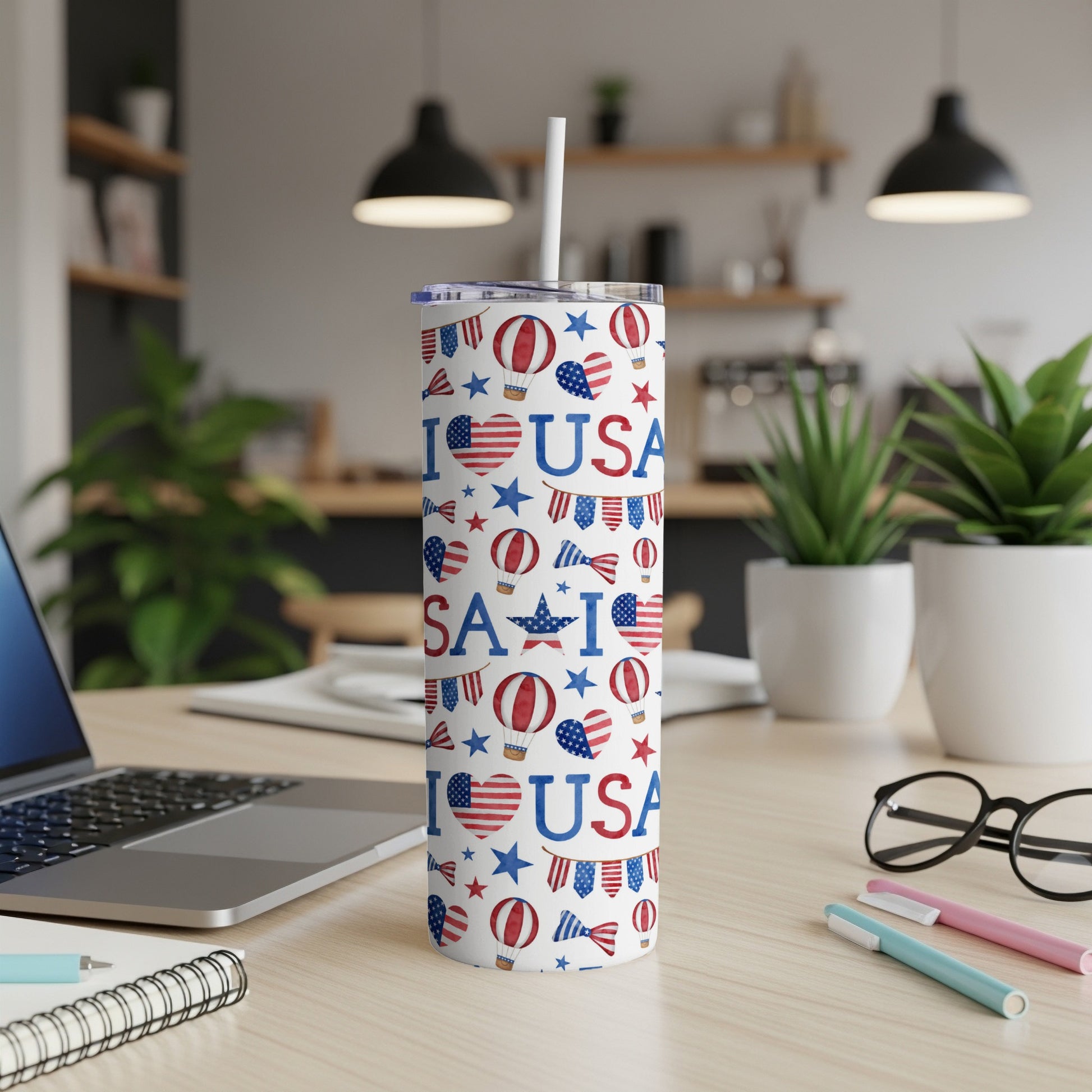White tumbler with USA, heart, and star pattern, featuring a straw.