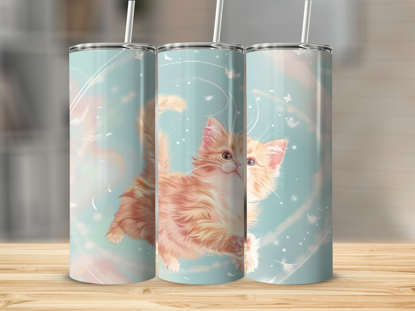 Three tumblers with a fluffy orange kitten and abstract background.