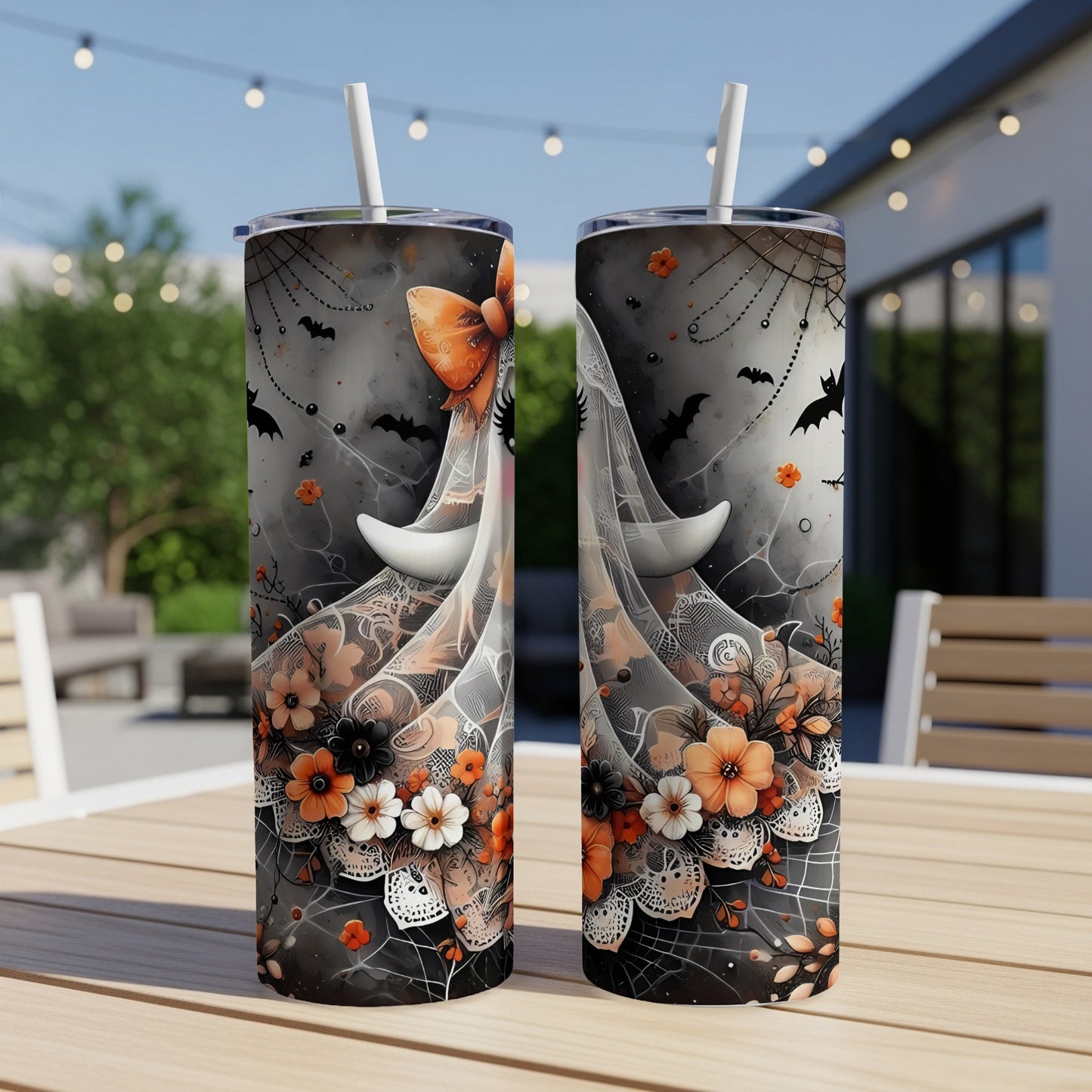 Two tumblers with a Halloween theme featuring bats, cobwebs, and floral accents.