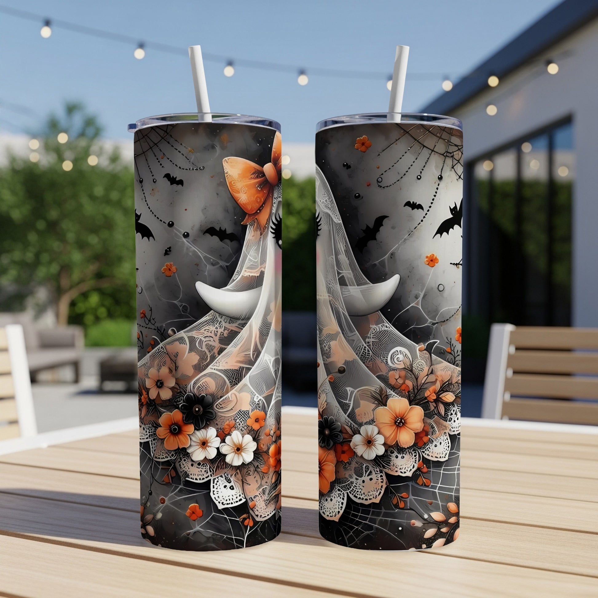 Two tumblers with a Halloween theme featuring bats, cobwebs, and floral accents.