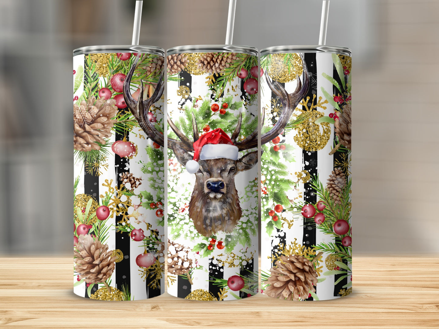 Three tall tumblers with a deer, pinecones, and festive holiday decorations.