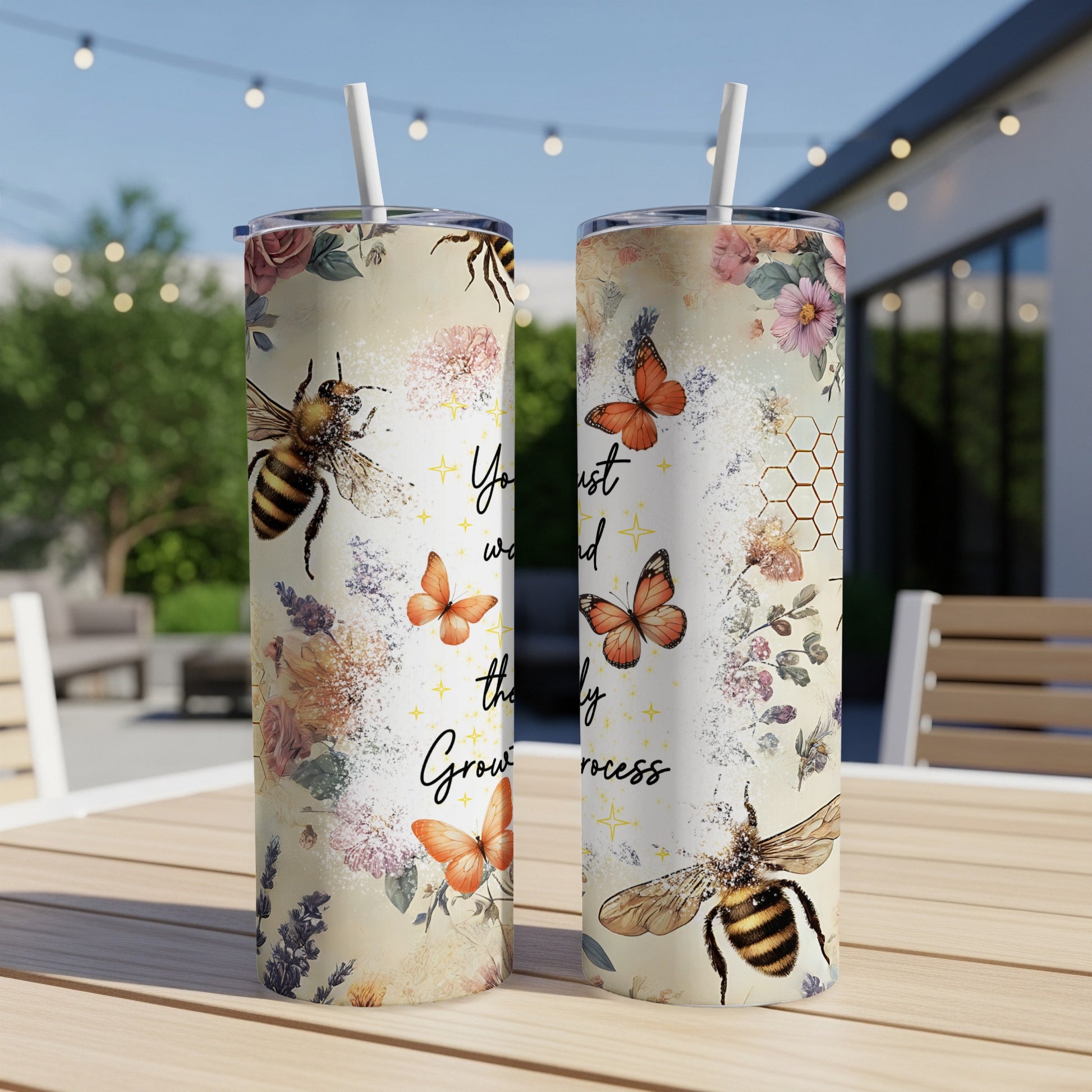 Two tumblers with bees, butterflies, and floral designs.