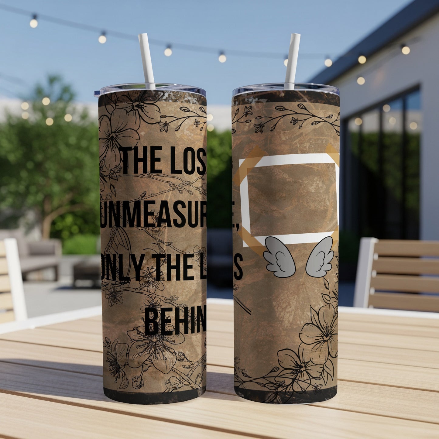 Two tumblers with floral design and text "THE LOS UNMEASUR ONLY THE L BEHIN" and wing graphic.