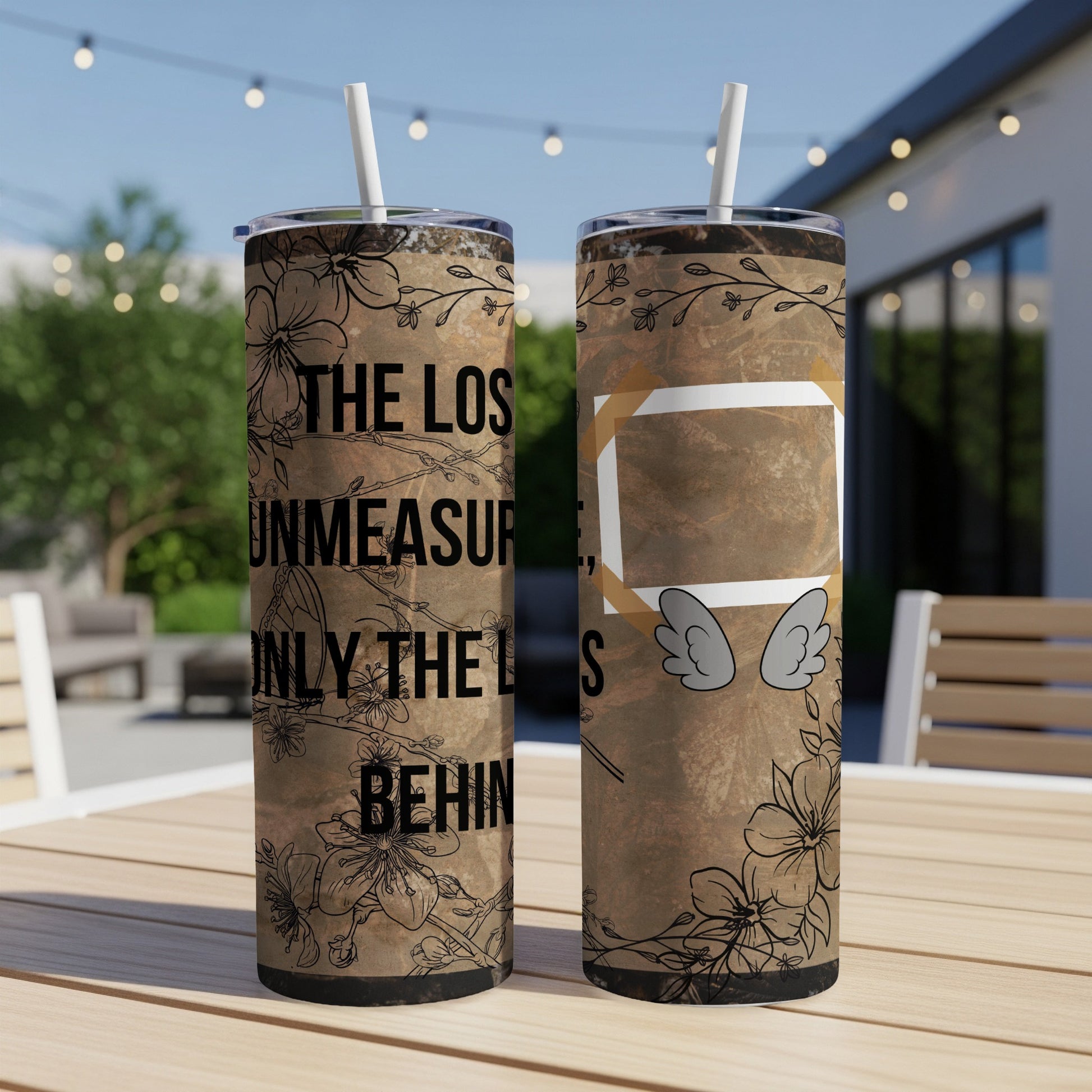 Two tumblers with floral design and text "THE LOS UNMEASUR ONLY THE L BEHIN" and wing graphic.