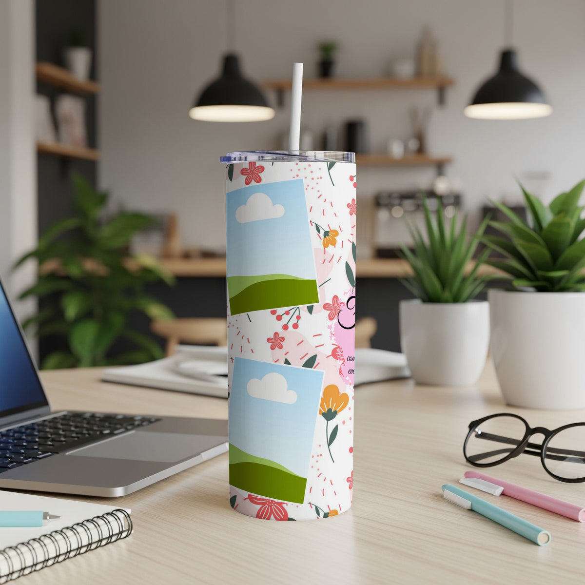 Tumbler with floral pattern, stacked photo frames and straw.