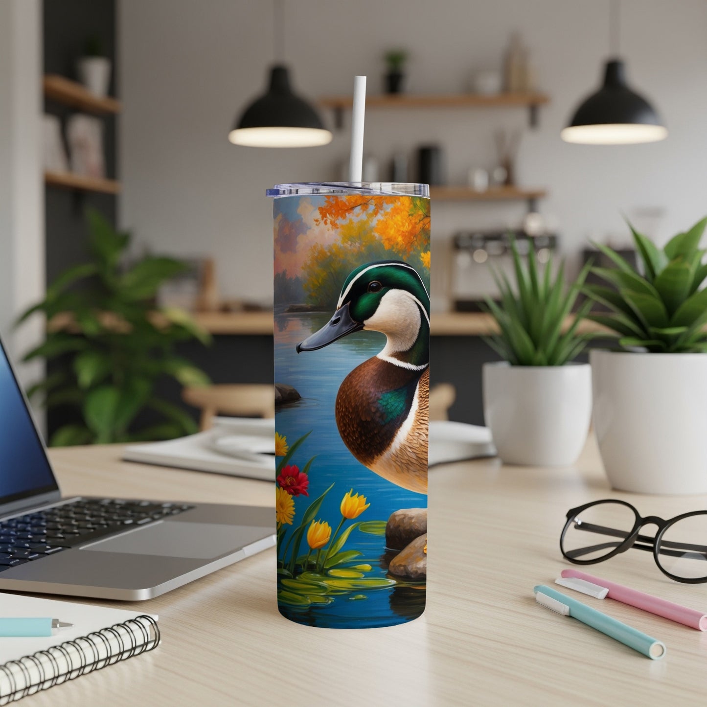 Ducks on water with colorful flowers on a tumbler.