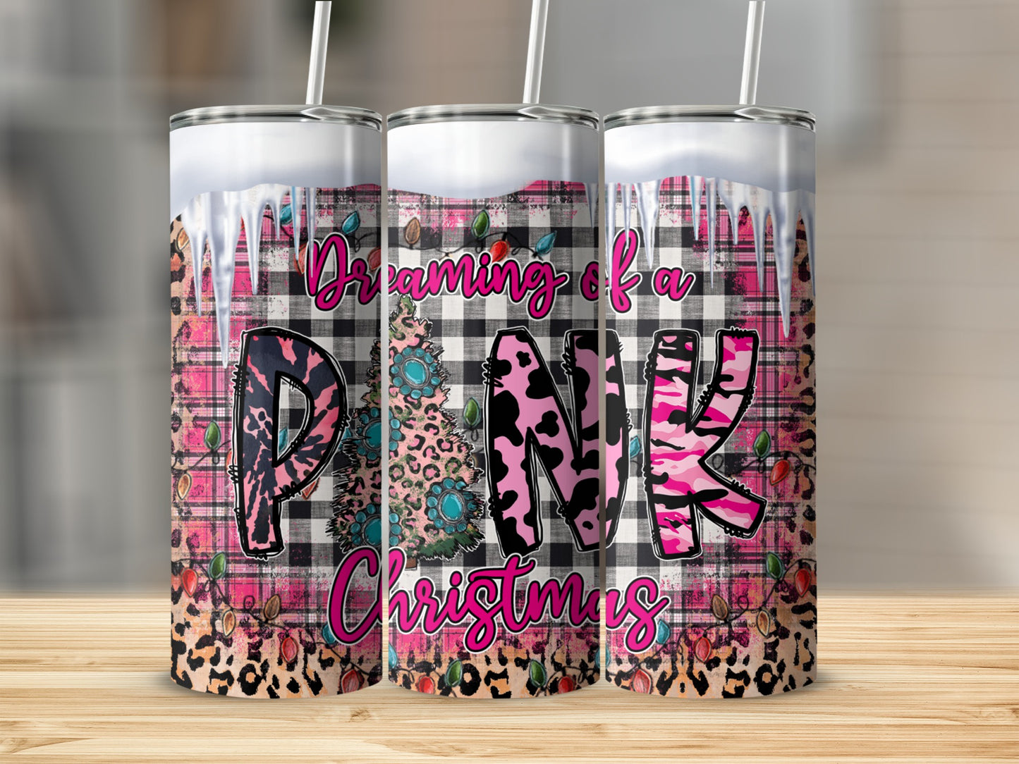 Three tumblers with pink, black, and white plaid, leopard print, and Christmas tree designs.