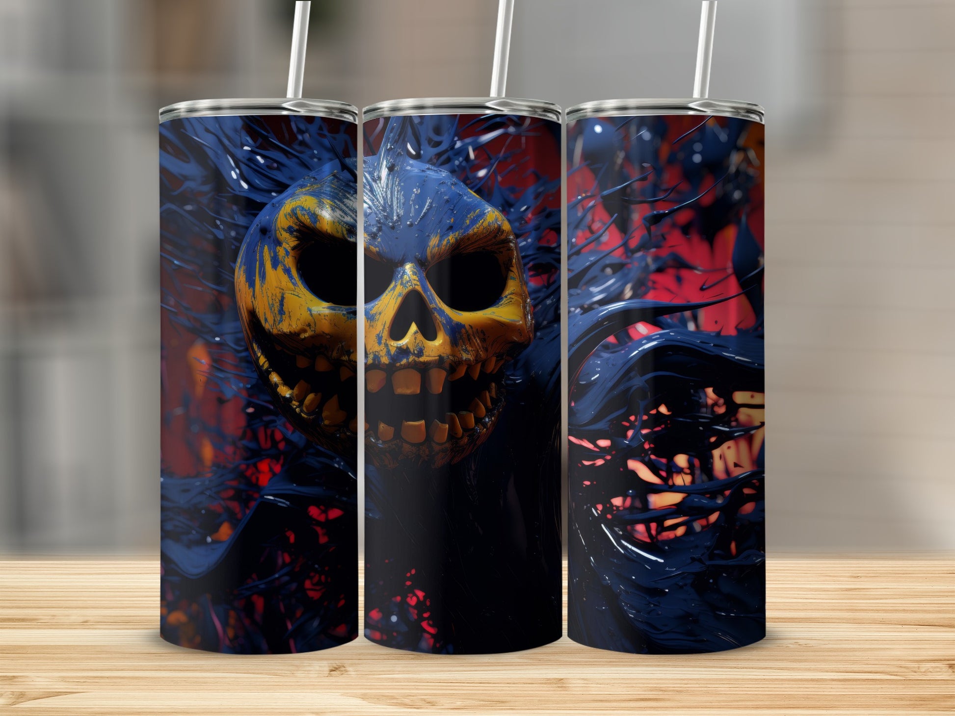 Three tumblers with a yellow and blue skull design against a dark, abstract background.