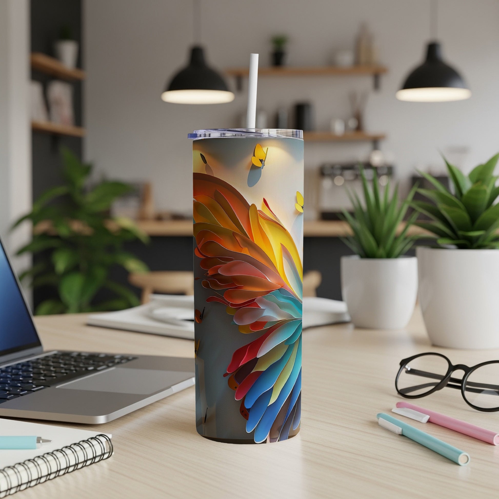 Colorful abstract feather pattern on a white tumbler with a straw.