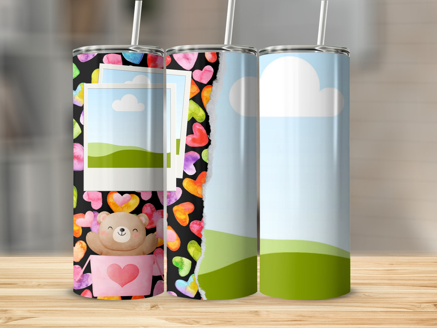 Three tumblers with watercolor heart patterns and landscape designs.