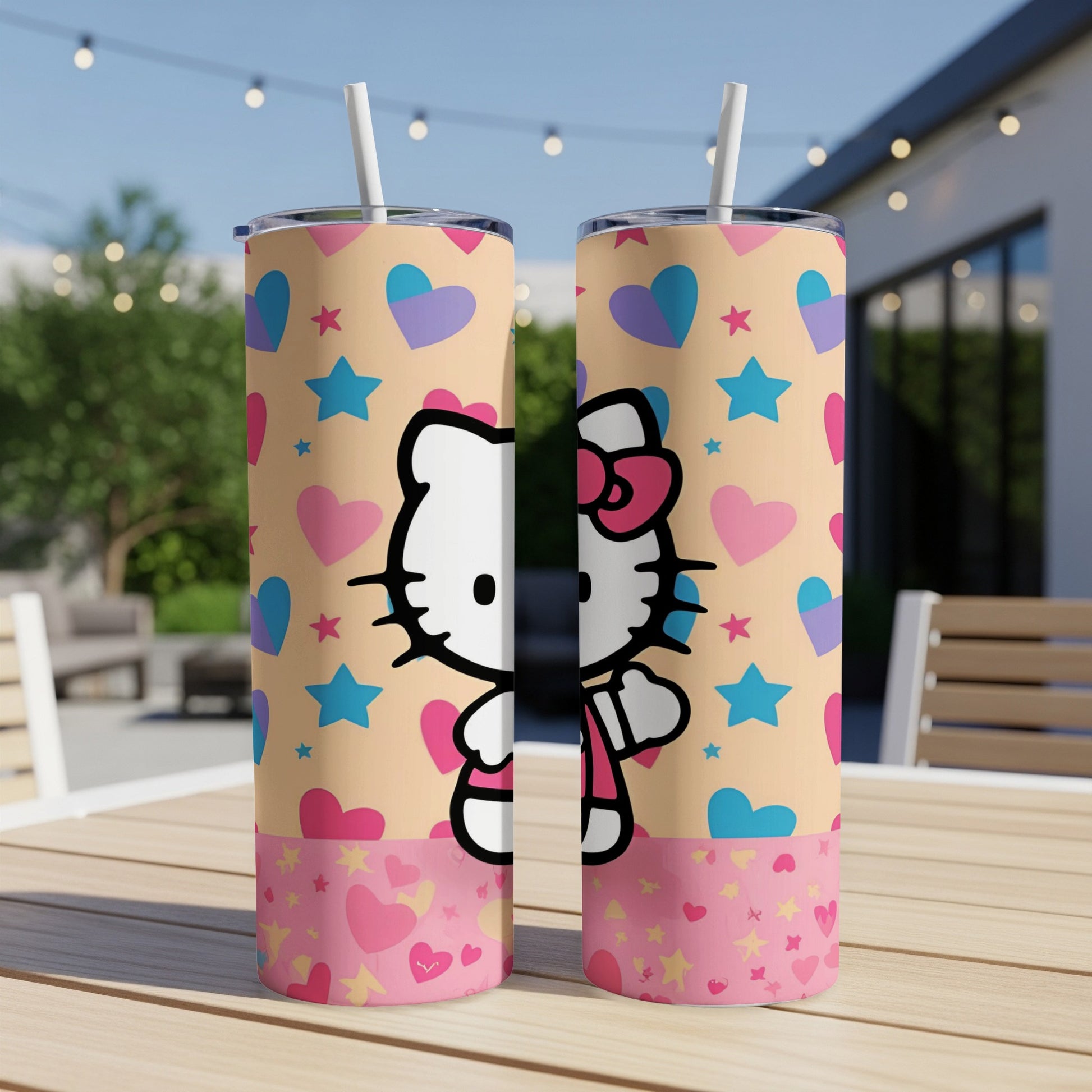 Two Hello Kitty tumblers with hearts and stars pattern on a table.