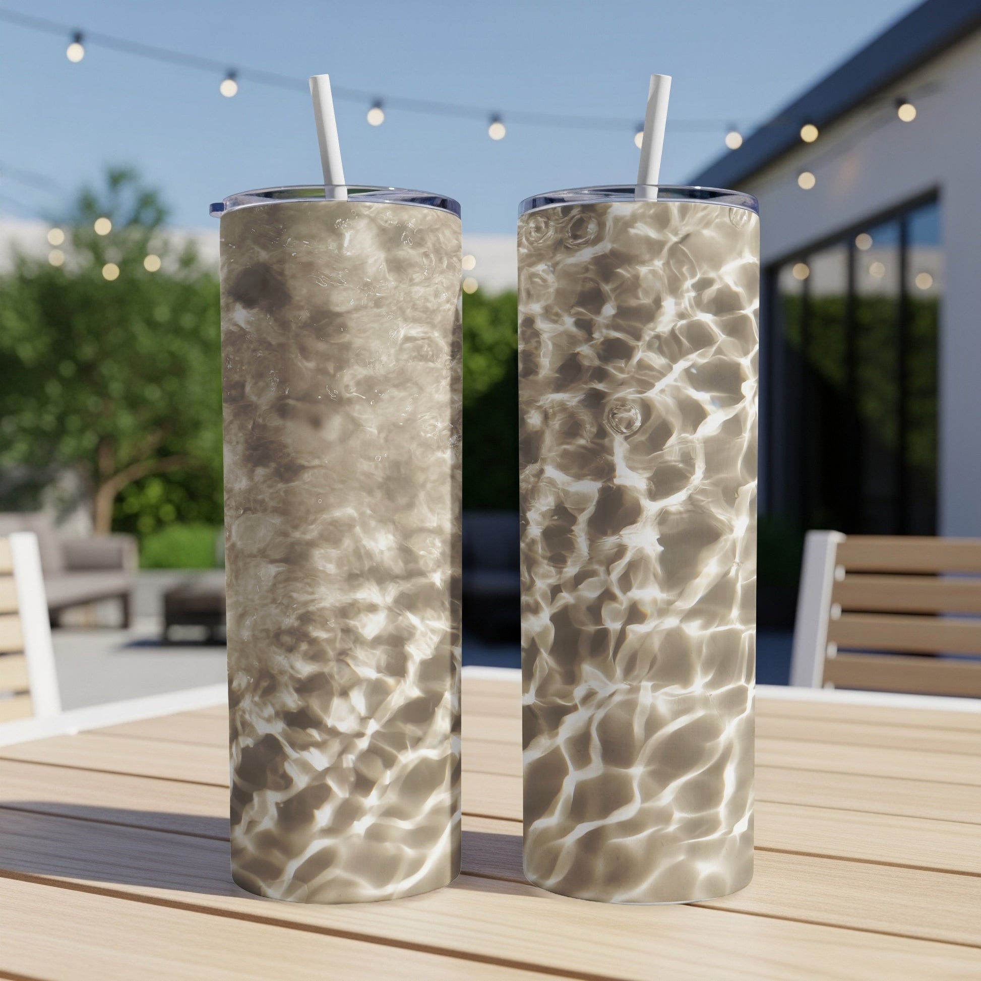 Two tumblers with a water ripple design sit on a table.