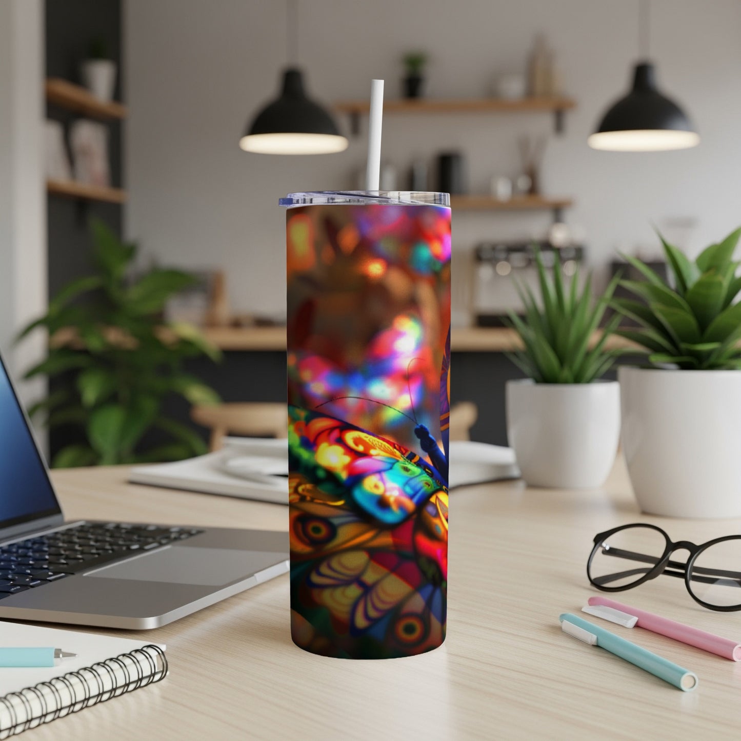 Tumbler with a colorful butterfly and psychedelic patterns.
