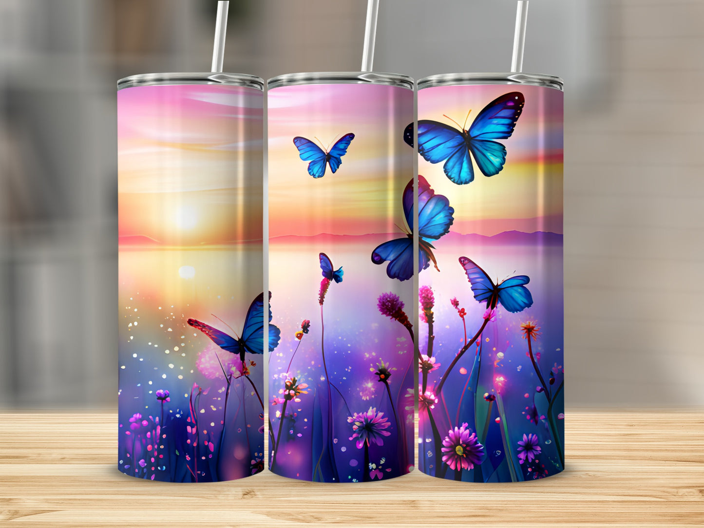Three tumblers with butterflies and a sunset scene.