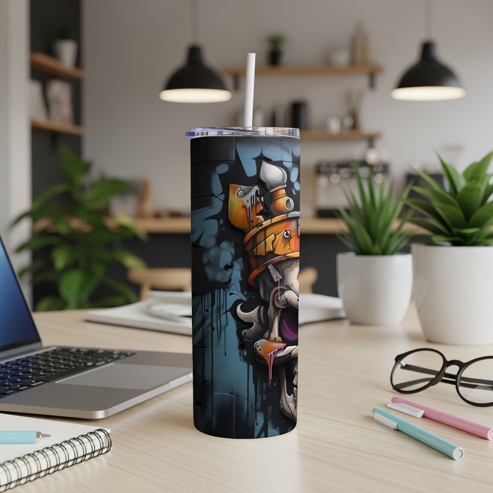 Graffiti-style monster artwork on a black tumbler with a white straw.