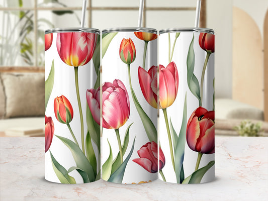 Three tumblers with red and pink tulips and green leaves against a blurred background.