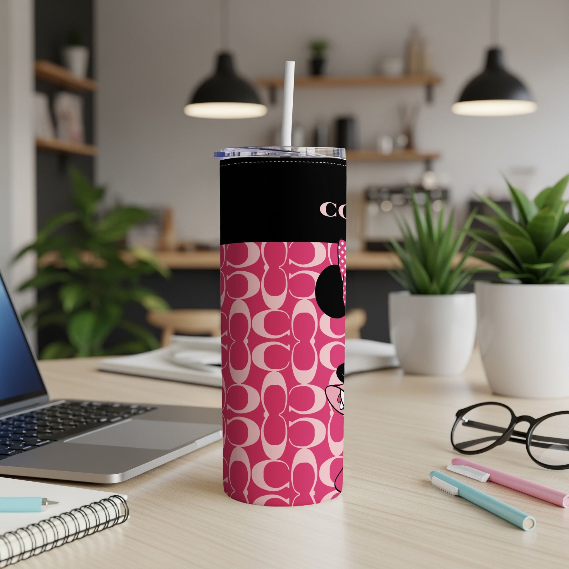 Pink tumbler with repeated Coach pattern and Minnie Mouse graphic.