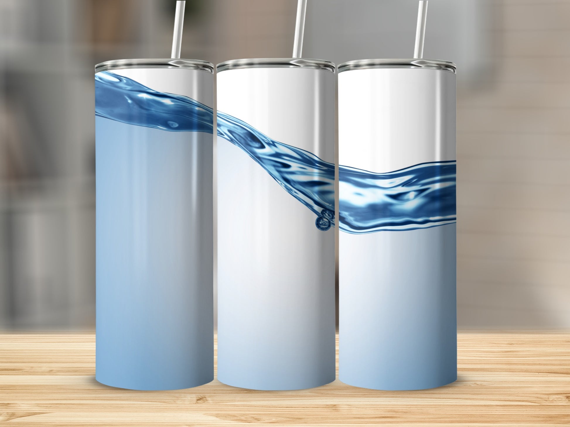 Three white tumblers with blue water wave design and straws.
