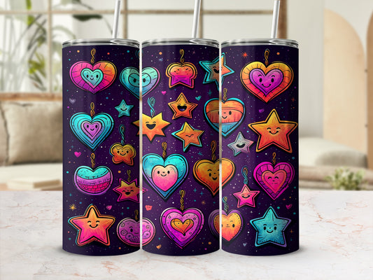 Three colorful heart and star tumblers with straws on a table.