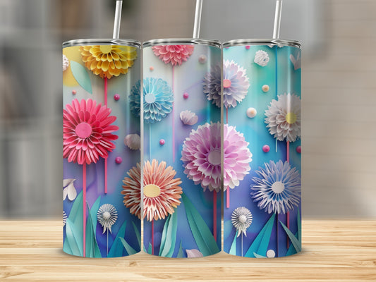 Three tumblers with colorful floral designs on a wooden surface.