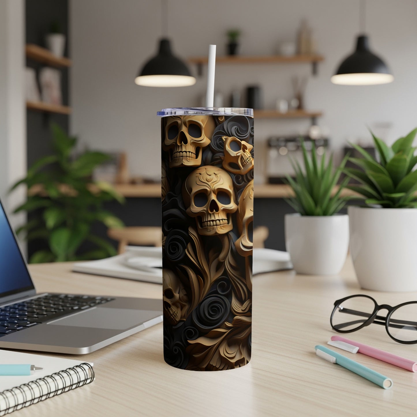 Golden skull pattern on a black tumbler with a white straw.