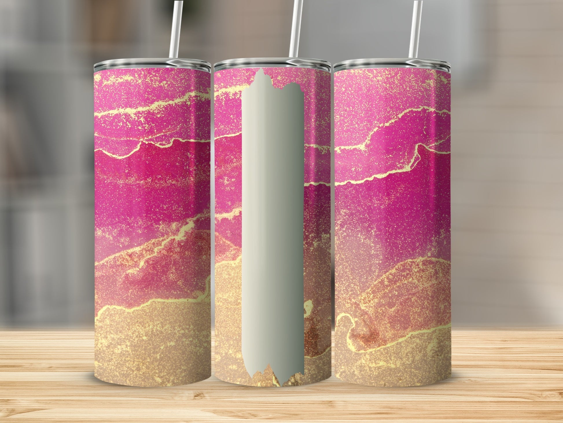 Three tumblers with pink and gold marbled design on wooden surface.
