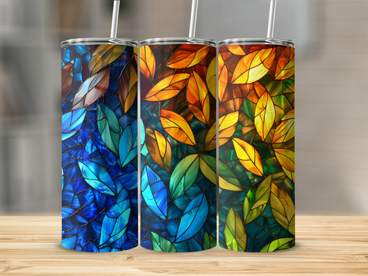Three tumblers with stained-glass leaf patterns in blue, orange, and green.