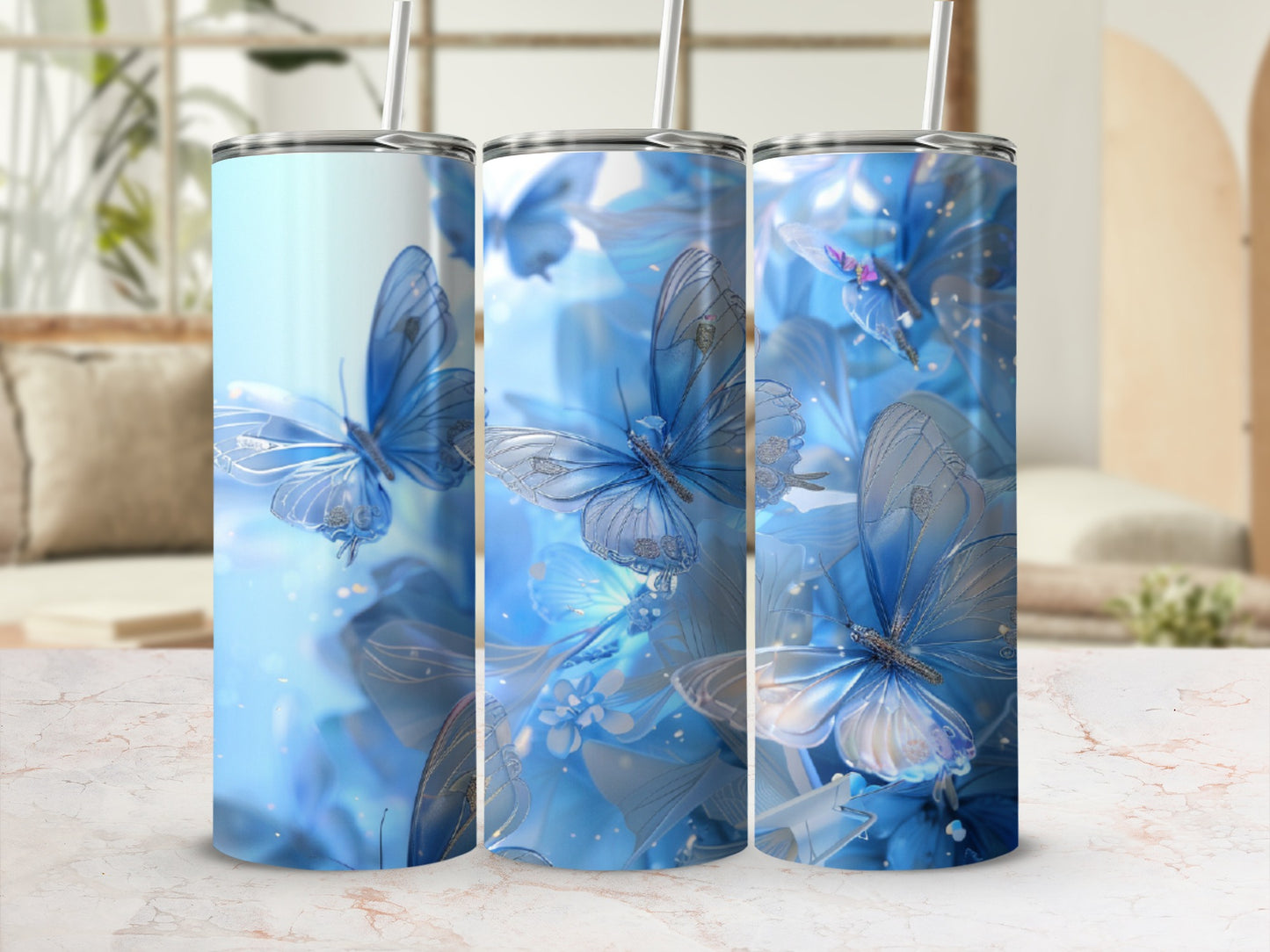 Three tumblers with blue butterflies and floral designs.