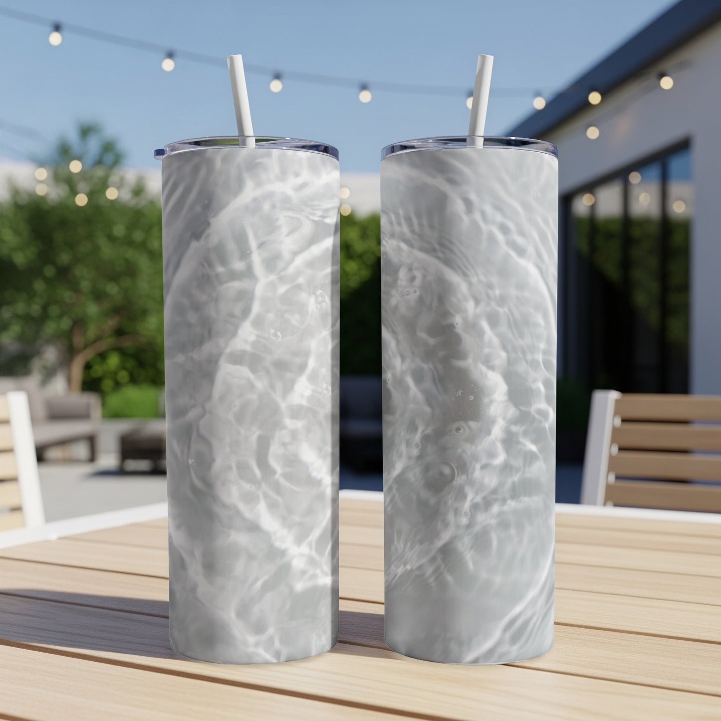 Two tall tumblers with water ripple pattern on a wooden table.
