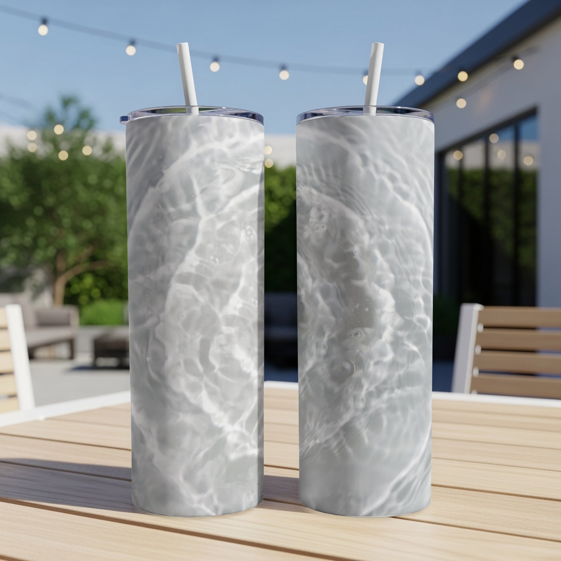 Two tall tumblers with water ripple pattern on a wooden table.